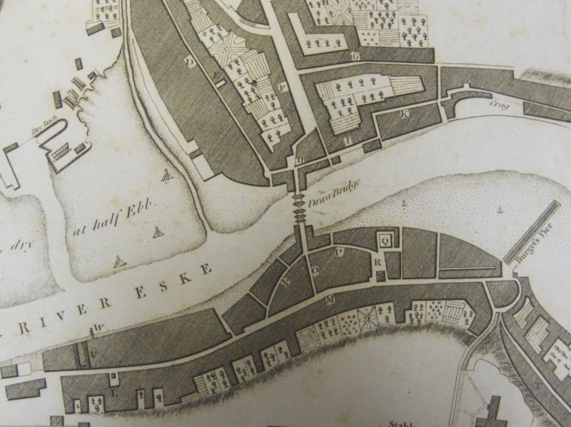 Detail of central Whitby during the 1770s, the streets of medieval origins gathered on each side of the ‘Draw Bridge’ and at this time many of the properties still had large gardens. ‘Plan of the Town and Harbour of Whitby. Made in the Year 1778 by L. Charlton.’ The market place being marked with a “R” on the plan. (Courtesy of: Whitby Museum, Library & Archive, Plans and Views of Whitby 769.942.74).