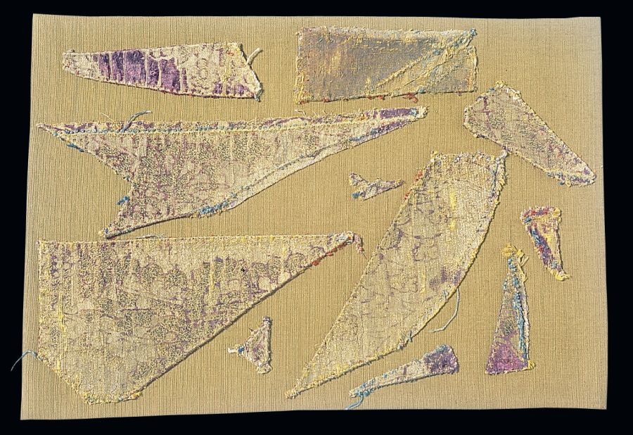 These ten fragments are some of the pieces left which are once believed to have been part of a 15th century chasuble. For this vestment an exquisite Italian silk with originally deep red pomegranates and shining membrane gold was used – today purple in colour and darkened metallic threads. Largest width, 68 cm. Photo: The IK Foundation, London.