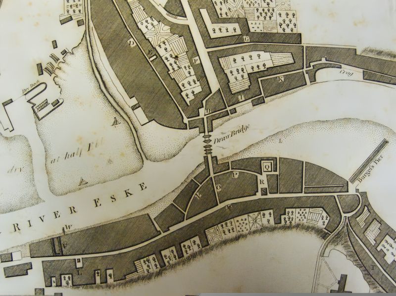 Central Whitby in the 1770s shows the streets with their medieval origins gathered on each side of the ‘Draw Bridge’; at this time, many properties still had extensive gardens. The mouth of the River Esk, leading to the North Sea, was the most critical trading route for textiles and other wares to and from Whitby in the 18th century. (Collection: Whitby Museum, Library & Archive, Plans and Views of Whitby 769.942.74, Made in the Year 1778 by L. Charlton).  