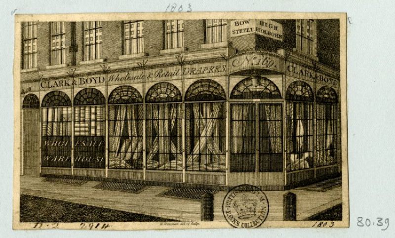 The outline for this type of corner warehouse of Clark & Boyd linen drapers in Holborn/London dated 1803  in pencil, opened up further possibilities with its larger number of display windows – drapery goods showed  off in folds, gathered in various decorative ways and neatly rolled. Courtesy of: © Trustees of the British  Museum, Trade cards, Banks 80.39. (Collection online).