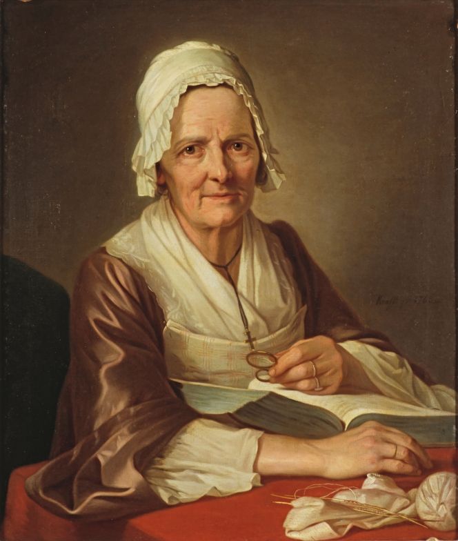 ‘Old Woman’ in 1768 by the Swedish artist Per Krafft the Elder (1724-1793). This contemporary oil on canvas is a representative depiction of an older woman’s modest way of dress within the rules for a non-aristocratic female individual. However, she was clearly of a well-to-do family who could afford to be portrayed, equally as her gown was of a fine brown plain silk quality, added with linen or cotton whitework embroidery, plain chemise sleeves, a matching cap and a pinned modesty piece of checked fabric. The open book, magnifying glass in her hand and ongoing knitting alike demonstrate some of her daily tasks. (Courtesy: National Museum, Stockholm, Sweden. No: NM 1709).