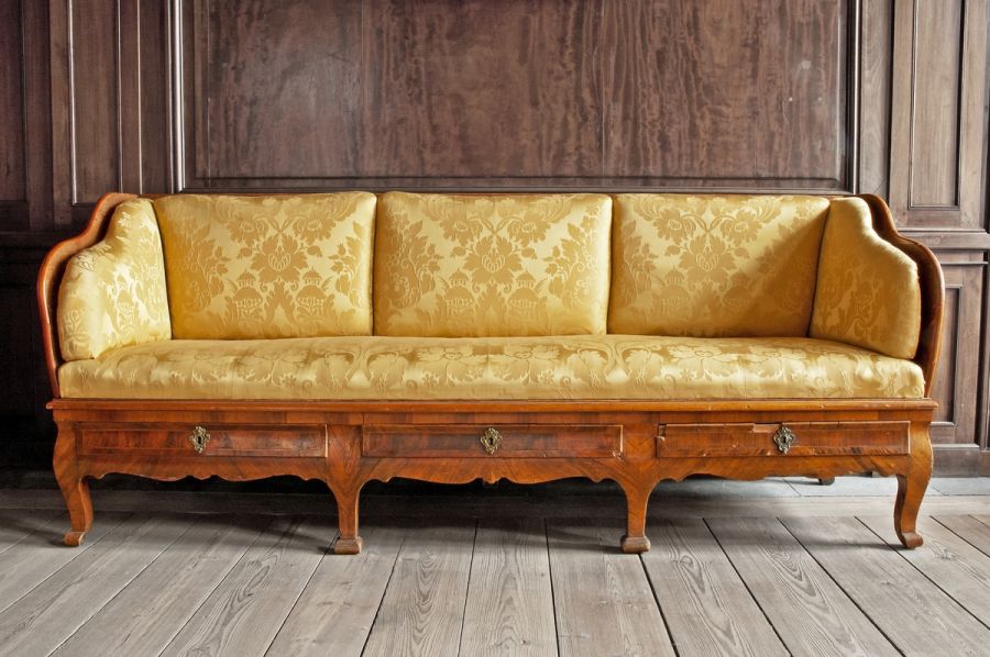 Few physical objects are preserved from mid-18th century Christinehof, so this sofa dating ca 1750s-1760s is a good comparison to the listed models in the 1758 inventory, as well as for described textiles in correspondence from the son Carl Gustaf to his father Carl Fredrik Piper in 1764. The son noted: ‘…it was needed 24 aln [ca 15 meter] damask, whereof it should be enough and for both side-cushions on both sides to be upholstered, so they can be turned around how one prefer if they got worn on one side’. It is interesting to notice the planning of the length of cloth, so that such an expensive fabric could last as long as possible in a wealthy home too. This depicted sofa was upholstered with a yellow silk damask, re-upholstered at unknown year, but possibly chosen to be similar in colour and design as was popular in the mid-18th century. Compare with the illustrated yellow silk damask sample below, kept in the Piper Family Archive. (Courtesy of: Nordic Museum, Sweden. Skanm.0193586. Digitalt Museum).