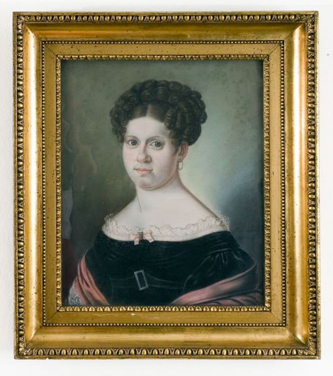 Portrait, by Pehr Lindhberg of Benedikta Sofia Flensburg (1788-1825) in 1824. She belonged to one of the merchant families in Malmö and her husband Mathias Flensburg (1779-1851) sold local as well as imported food and other goods in his shop. Her clothing reveals some sort of wealth: including a black velvet dress with lace decorations and a red ornamented shawl. (Courtesy of: Malmö Museum, No: MHM 002002).