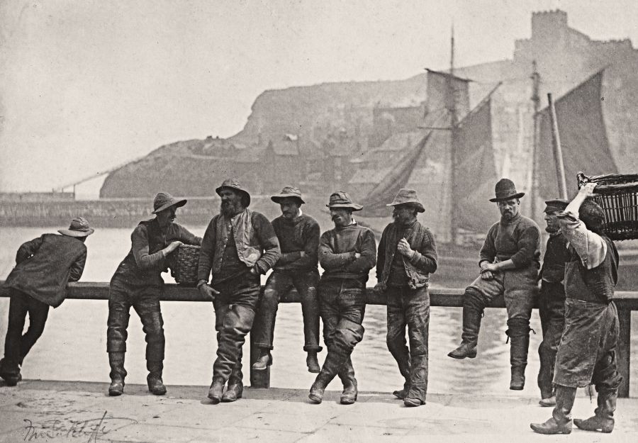 Whitby fishermen in Whitby harbour, circa 1885, most wearing blue knitted ganseys. (Courtesy: National Gallery of Art, Washington. Public Domain). Photo: Frank Meadow Sutcliffe.